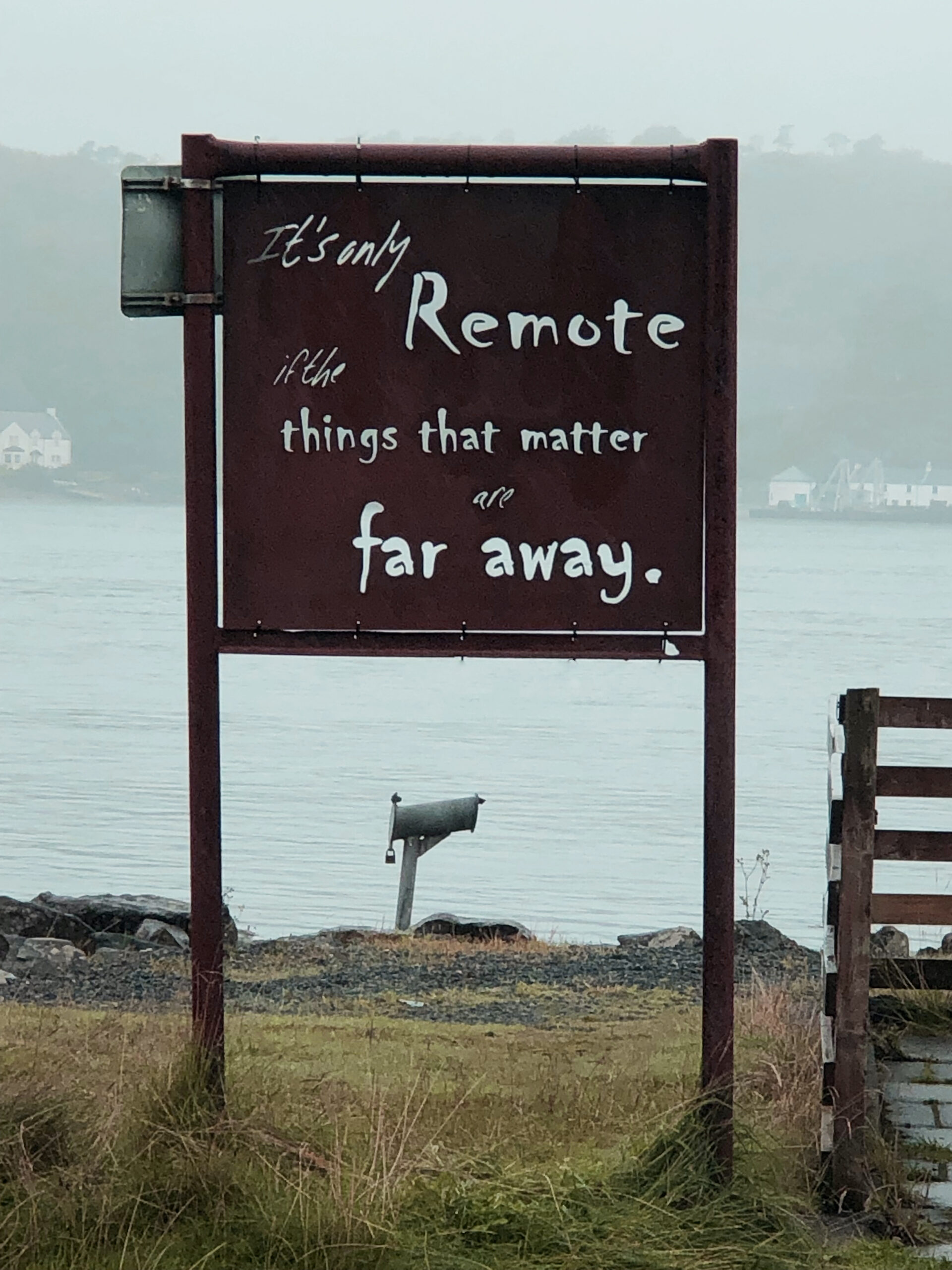 Photo of a rusted sign, with the words 'It's only remote if the things that matter are far away.' cut into it.
